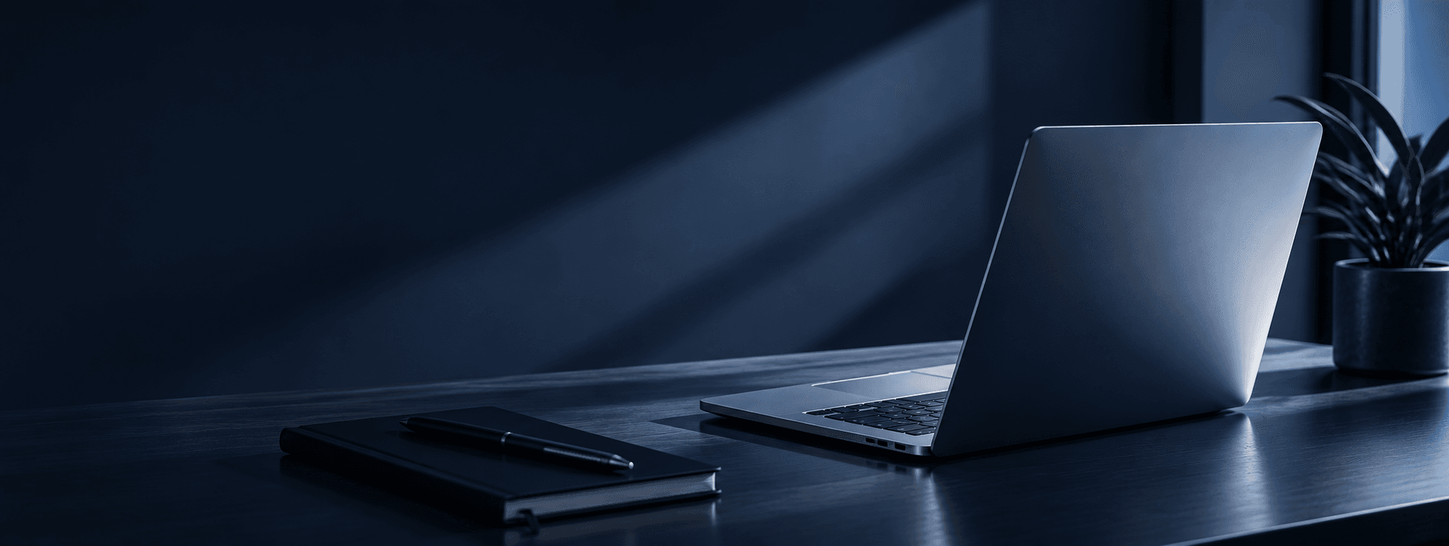 Laptop and notebook on a workspace